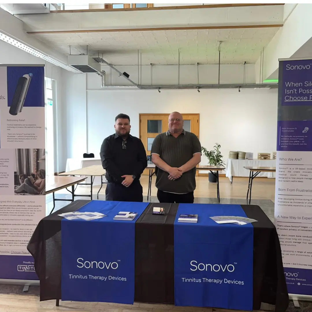 Jack Bridge & Gary Bridge standing behind a Sonovo™ table at an event with promotional materials.